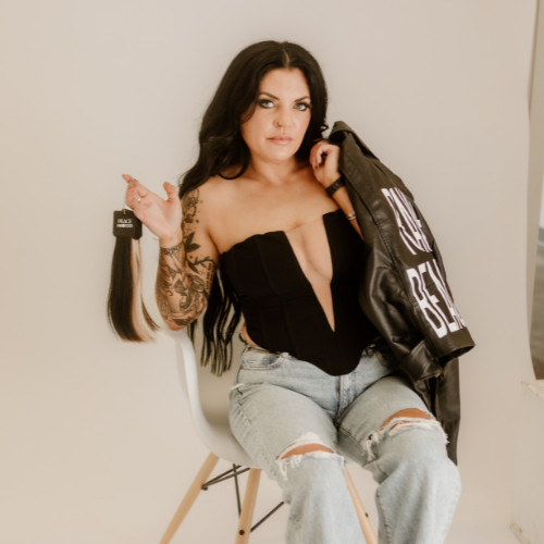 Picture of a woman with black hair, having hair extensions sewn into her hair