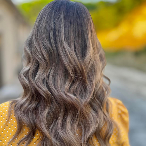 3 | Rawe Beauty Picture of a woman with black hair, having hair extensions sewn into her hair